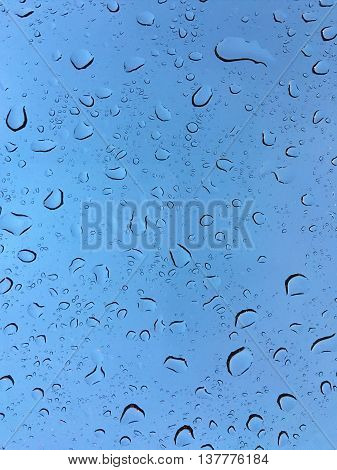 The Raindrops on glass in rainy day.