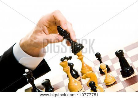 Image of human hand holding chess