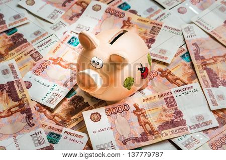 Piggy Bank In A Pile Of Russian Five Thousand Banknotes