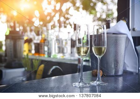 Two glasses of champagne in outdoor resort bar