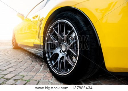 Back of a yellow modern sport car in sunset
