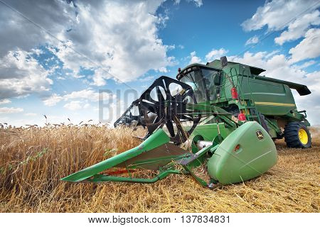 Dobrich Bulgaria - July 08: Modern John Deere combine harvesting grain in the field near the town Dobrich Bulgaria July 08 2016