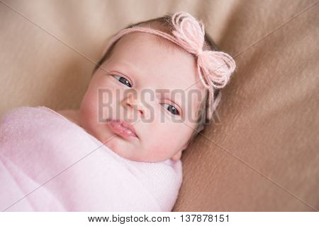 Portrait of a beautiful baby girl in pink