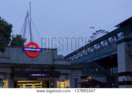 LONDON, UNITED KINGDOM - SEPTEMBER 11 2015: Embakment metro station at twilight in London with millenium wheel in the background