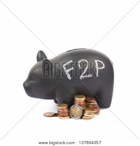 Word F2P written with chalk on a black ceramic piggy bank coin container next to a pile of euro coins, composition isolated over the white background