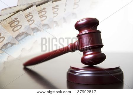 Judge gavel with money in background and corruption.