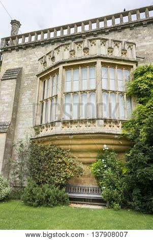 LACOCK ABBEY, LACOCK, WILTSHIRE, UK, JUNE 2016 - Oriel window with bench underneath at Lacock Abbey Lacock Wiltshire UK