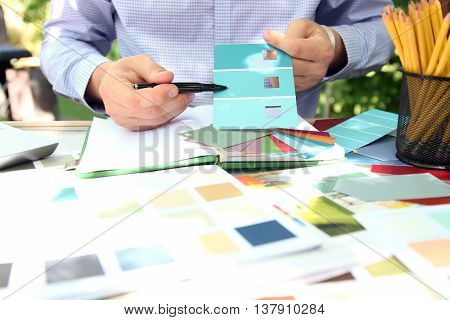 sales agent choosing color samples for design project.