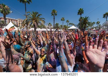 BARCELONA, SPAIN - JULY 9 2014:People put hands in a air at Holi festival at Escenario del Moll de la Fusta.