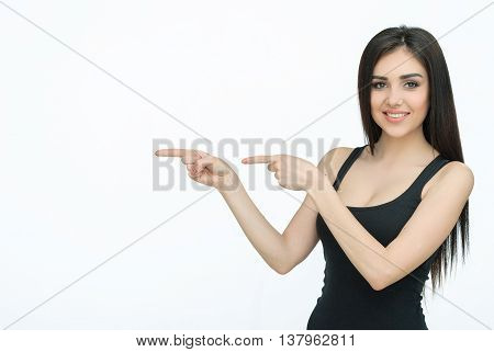 Advertising. Yound beautiful woman showing something. Girl pointing up on something. Woman pointing on copy space
