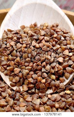 Organic buckwheat groats in spoon on table