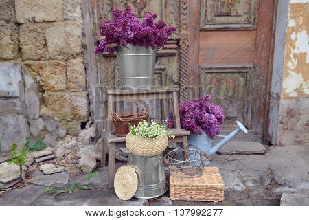 Purple lilac and may-lily flowers on old porch