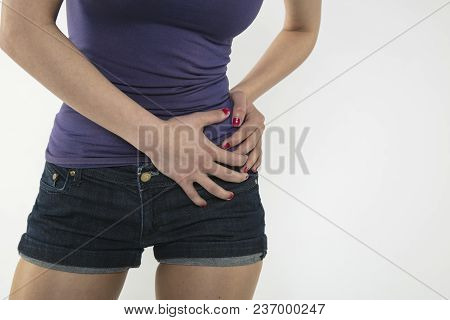 A Young Woman Is Struggling With Pain, Isolated On Background