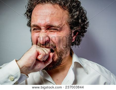 derision, man with intense expression, white shirt