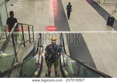 Passenger In Airport Or Modern Train Station, Man Commuter Travels With Luggage. Backpack, Knapsack,