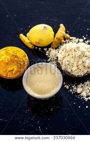 Chana,haldi,limbo Ka Ubtan Or Ayurvedic Face Pack Of Turmeric, Lemon, And Gram Flour On Wooden Surfa