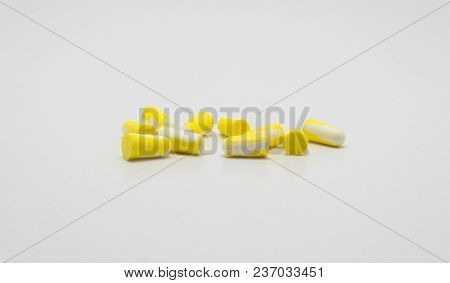 Ear Plugs For Protection Against Noise In Yellow And White. Isolated On White Background With Clippi