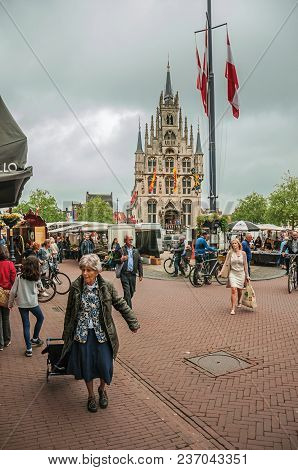 Gouda, Southern Netherlands - June 29, 2017. People At Market Square Fair With Gothic City Hall And 