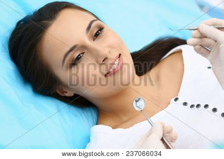 Young Female Patient Visiting Dentist Office.beautiful Woman With Healthy Straight White Teeth Sitti