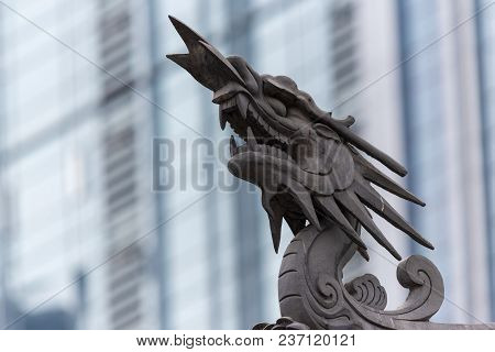 Dragon Sculpture On Daci Buddhist Temple Roof Against Modern Building In Chengdu, China