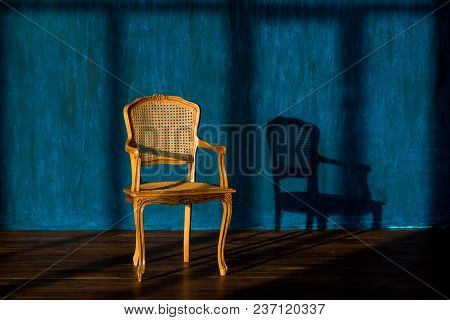 Old Chair On A Blue Wall Background