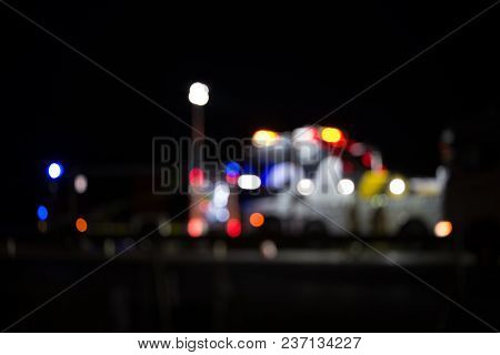 Highway Accident With Fire Trucks And Towing Truck Clearing Wreckage, Out Of Focus, Night Scene