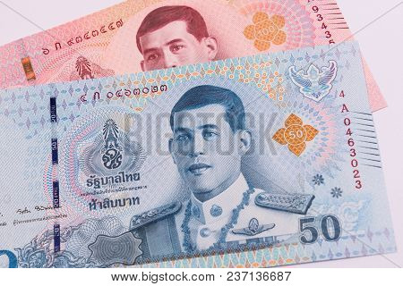 Close Up Of New 50 And 100 Thai Baht Banknote. Thai Bath With The Image Of King Maha Vajiralongkorn 