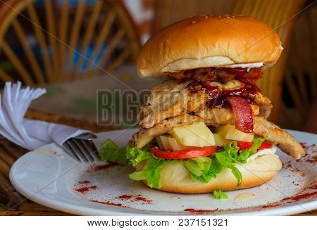 Big Burger On The Plate. Beef Burger With Cheese, Ham And Tomato On White Plate. Rich Nutrititive Br