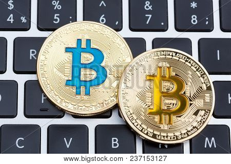Digital Currency Physical Golden Bitcoin Coins On Black Computer Keyboard. High Resolution Photo.