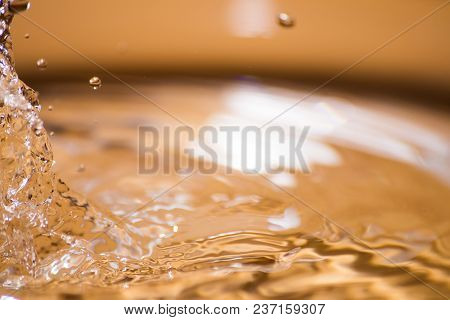 Shining Drop Of Water Colored Of Orange Isolated Composition