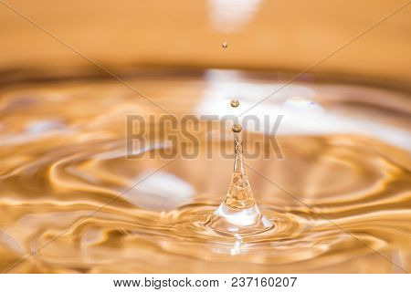 Shining Drop Of Water Colored Of Orange Isolated Composition