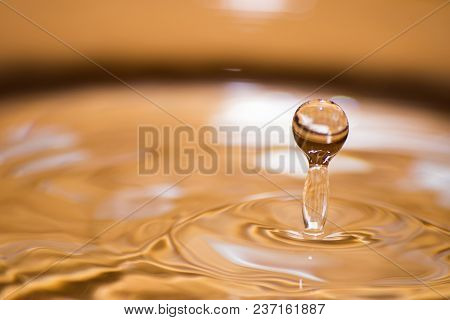 Shining Drop Of Water Colored Of Orange Isolated Composition