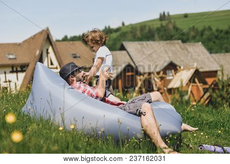 Father And Son Resting On An Air Sofa In The Mountains. Lamzac. Travel, Family Vacation In The Mount