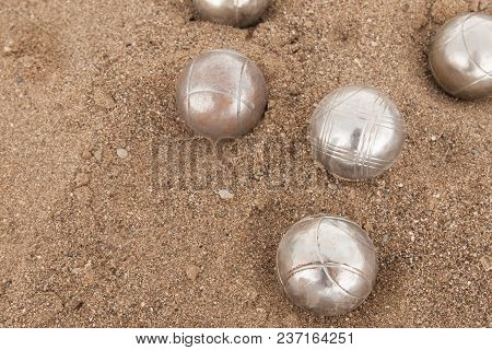 Beach. A Game Of Bocha. Brilliant Silver Balls For A Bocha On The Sand.