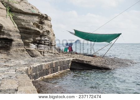 Yongmeori Beach, Sanbang-ro, Jeju Island, South Korea - August 28 2017: Local Women Selling Fresh Se