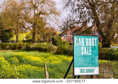 Car Boot Sale This Sunday Sign With Field On Bachground.