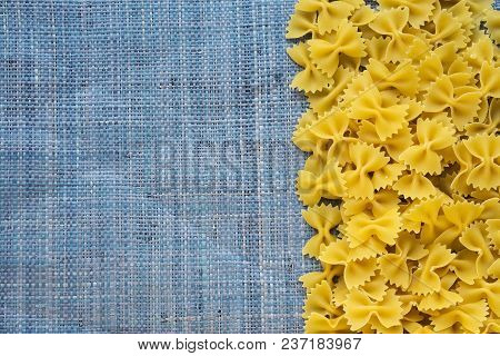 Farfalle Raw Farfallini Beautiful Decomposed Pasta With The Right, On Its Side On A Rustic Blue Knit