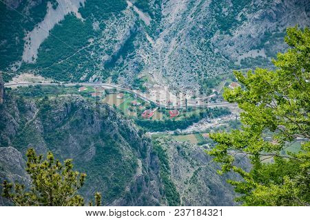 A Small Village Is At The Bottom Of A Deep Canyon