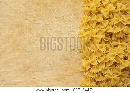 Farfalle Raw Farfallini Beautiful Laid Out Pasta With The Right, Side View On A Wooden Table Top Wit