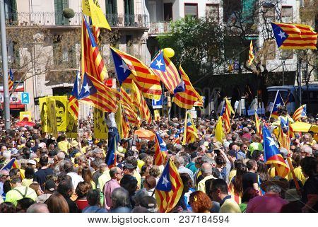 BARCELONA, SPAIN - APRIL 15, 2018: Catalans take part in the Llibertat Presos Politics (free political prisoners) protest march at Placa Espanya in support of jailed Catalan politicians.