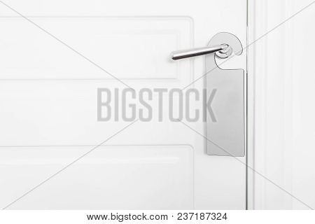 Door Knob With Empty Label On A Door Handle For Your Text. Empty White Flyer Mockup Hang On Door Han