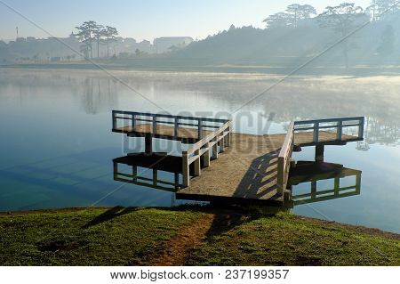 Destination For Vietnam Travel At Da Lat City, Mist Evaporate From Surface Water Of Lake, Silhouette