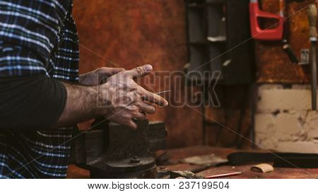 Man Works In Carpentry Workshop. He Connects Blade Of Ax And Handle. Men At Work. Hand Work.
