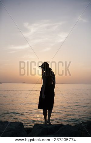 Beautiful Girl On A Sunset Background On A Sandy Beach. Woman.