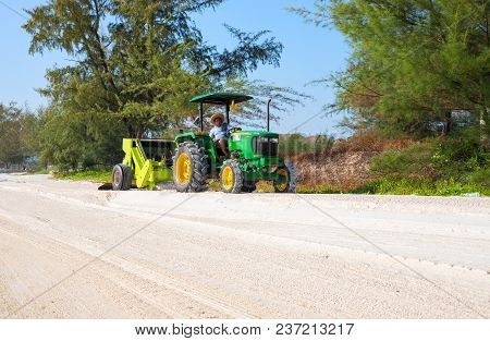 Koh Rong Island, Cambodia - 09 April 2018: White Sand Beach And Tractor Cleaning The Sand. Tropical 