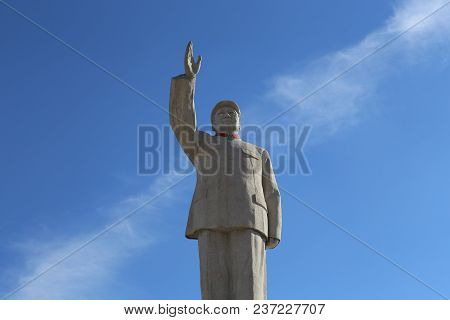Image Of Statue Of Chairman Mao Zedong Against A Blue Sky In Lijiang, China Captured On November 28,
