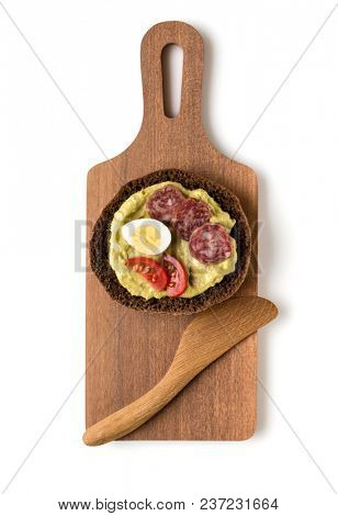 Open  faced sausage sandwich canape or crostini on a wooden serving board  isolated on white background closeup. Top view.