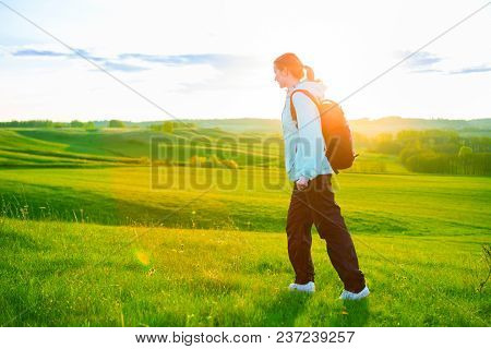 Young Woman Hiking In Beautiful Nature. Sports And Healthy Lifestyle Concept.