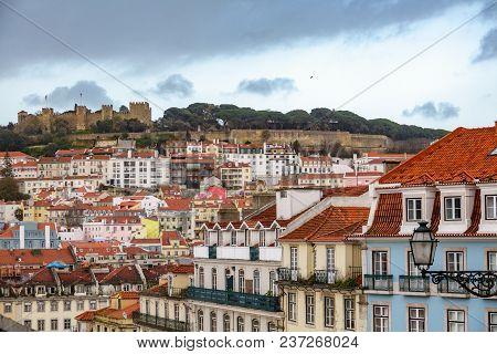 Castle Of Saint George Over The Hill And Lisbon Downtown At Dusk