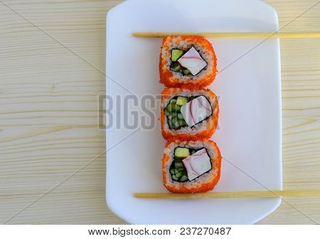 Sushi A Dish Of Traditional Japanese Cuisine Cooked From Rice, Calves Of A Salmon, Crabmeat, Avocado